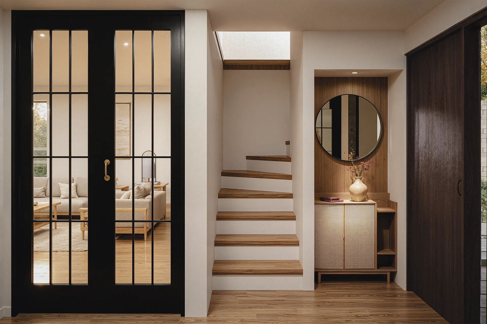 Hall de acceso con puerta vidriada, espejo redondo y escalera, Casa James Joyce